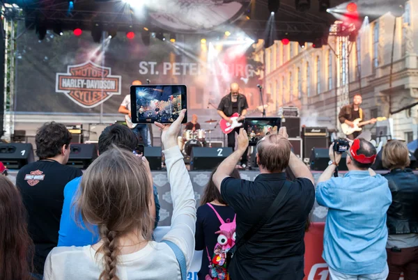Spectators shooting a concert rock band on your mobile devices