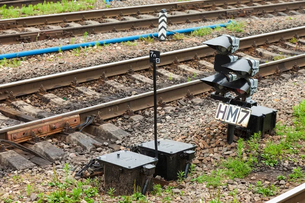 View of the railway track and traffic light on a summer day