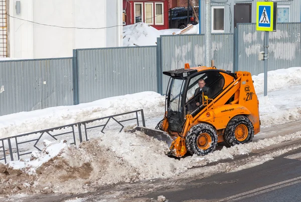 Snow cleaning pavements and streets of city which are covered in