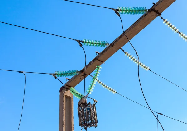 Power line wiring and insulators system over blue sky