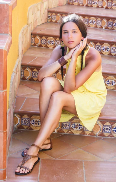 Beautiful girl on the stairs decorated with ceramic tiles. Sicily. Italy