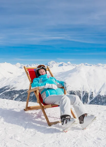 View of woman resting on chair in mountains.  Ski resort Livigno