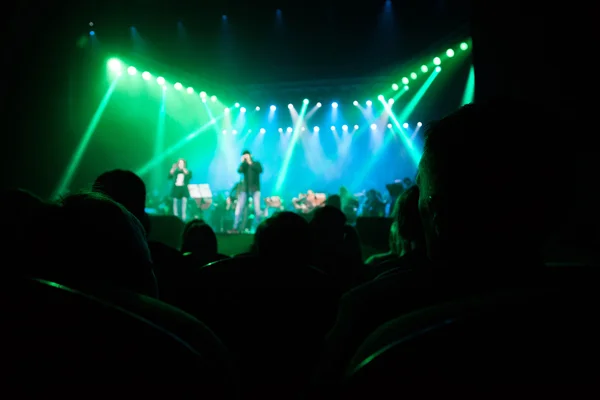 Audience watching the scene with artists.