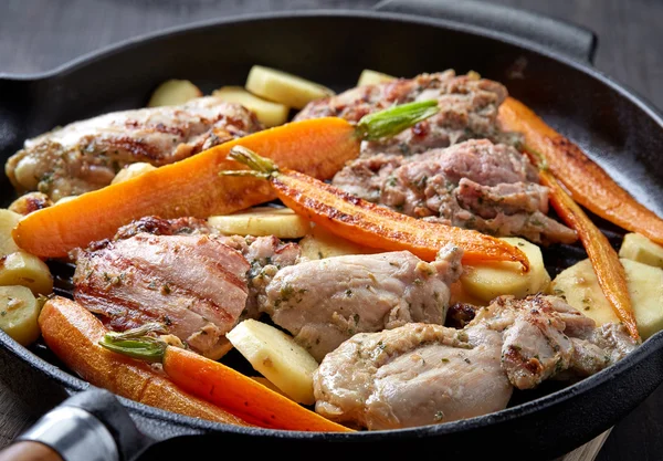 Chicken meat and roasted vegetables on cooking pan