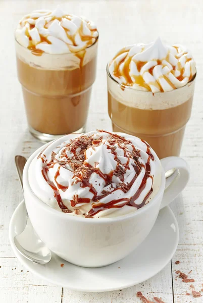Various coffee cups with whipped cream
