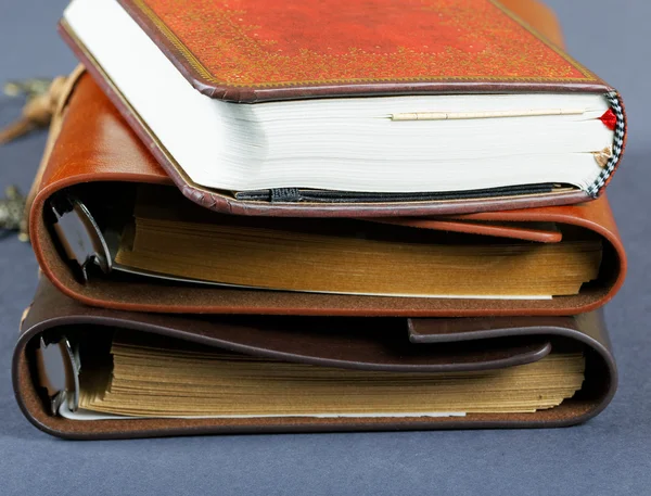 Pile of notebooks in leather covers close up