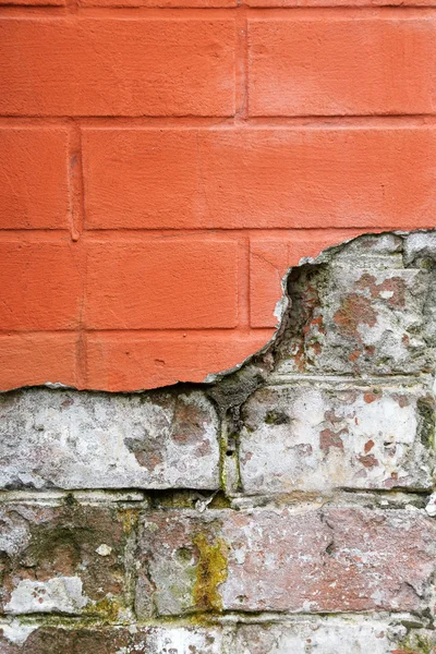 Red broken brick wall close up