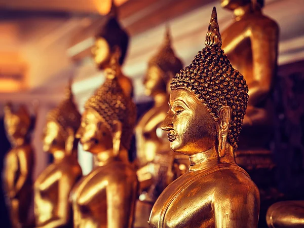 Golden Buddha statues in buddhist temple