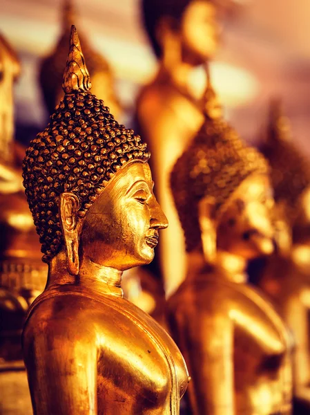 Golden Buddha statues in buddhist temple