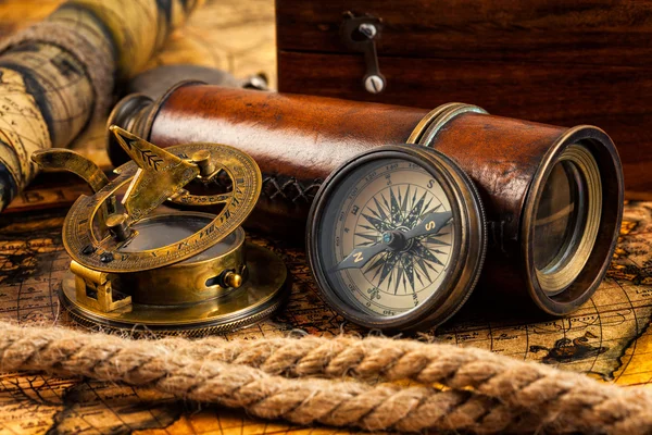 Old vintage compass and navigation instruments on ancient map