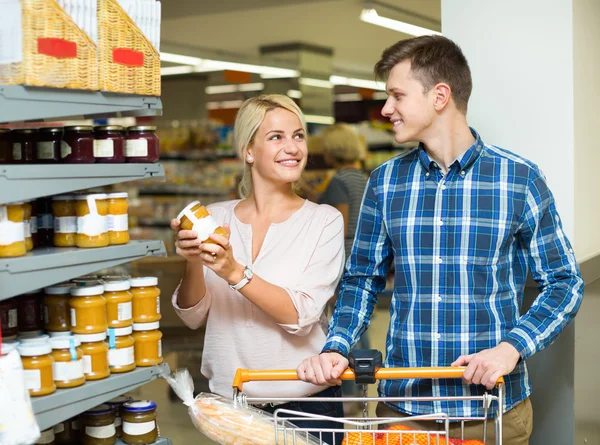 Family purchasing canned food for week