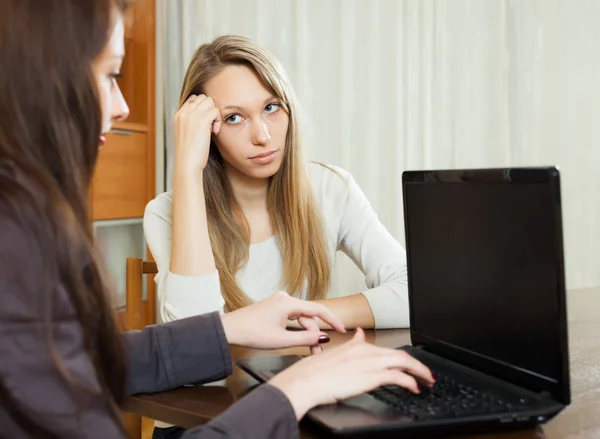 Woman talking with employee   at table