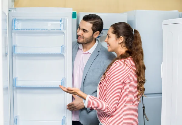 Customers looking at large fridges