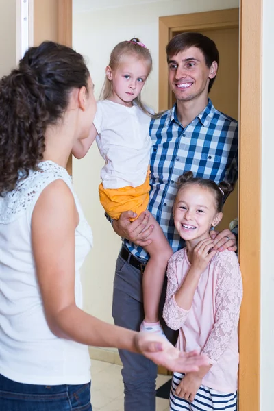 Adults and kids meeting at doorway