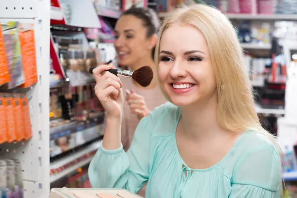 Adult girl choosing face powder