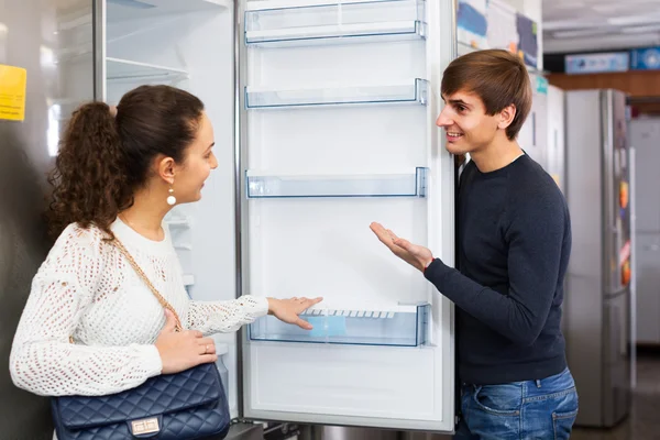 Couple choosing new refrigerator