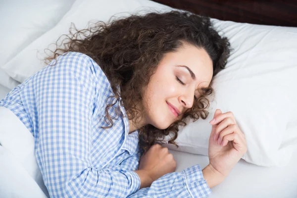 Cute adult girl smiling in her sleep