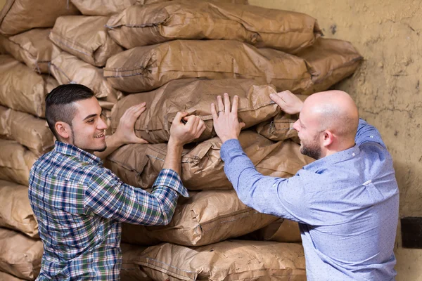 Workers carrying bags of cement