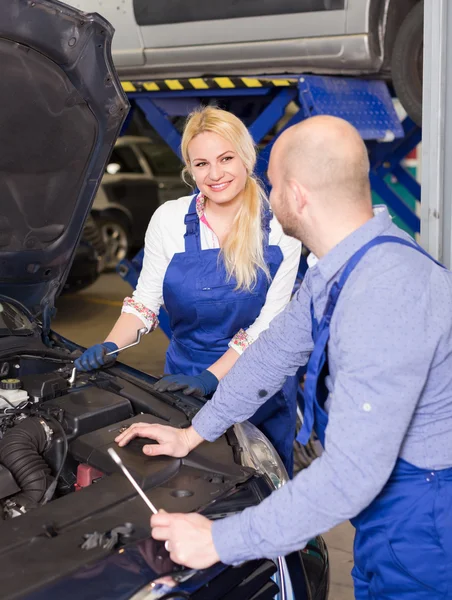 Auto service center crew near car