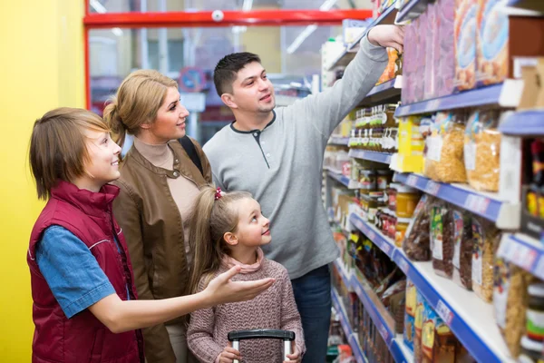 Family choosing cereal in supermarket