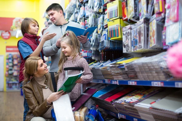 Family choosing stationery in store