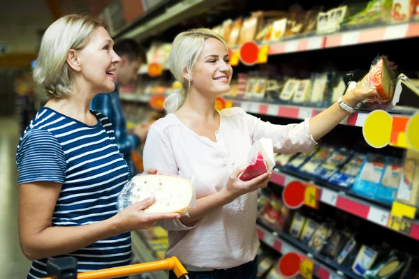 Girl with senior mother in cheese section