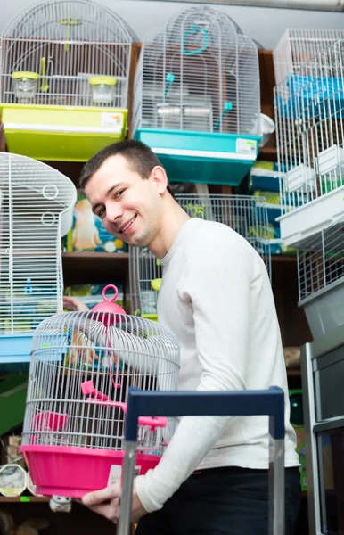 Guy buying cage for bird