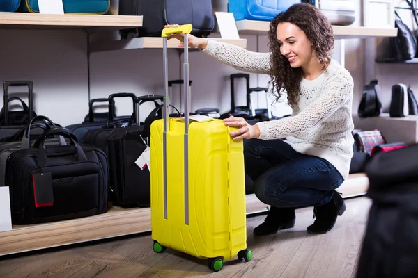 Woman selecting handy trunk in store