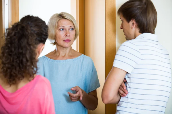 Couple arguing with mature woman