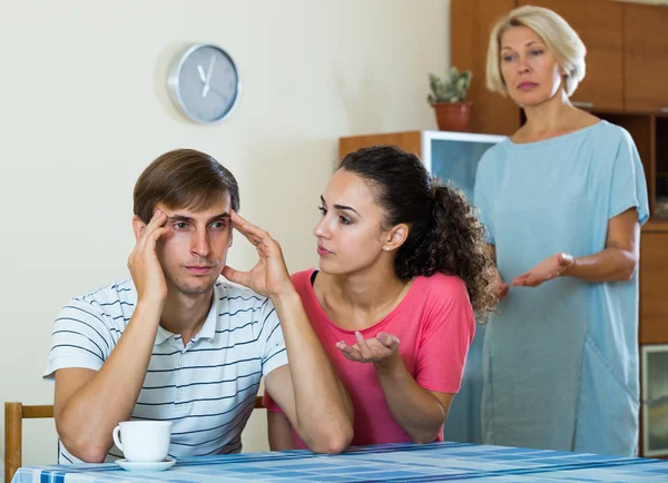 Guy having argue with wife and mother-in-law