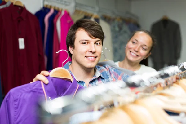 Couple chooses clothes at the store