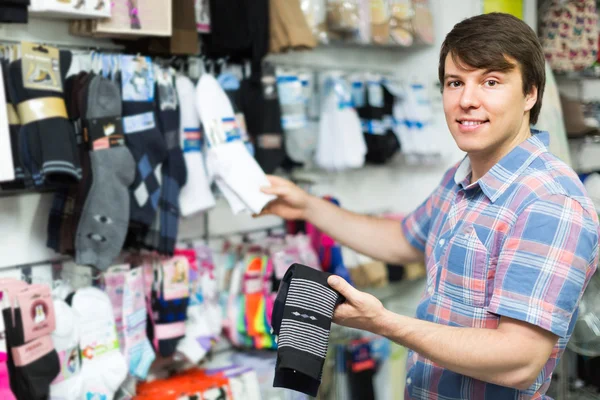 Young man buying socks