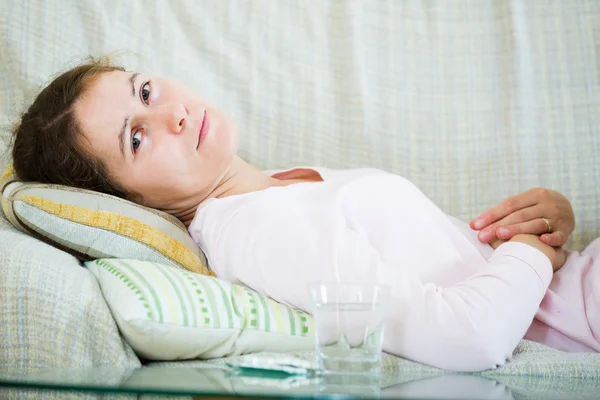 Portrait of girl folding up with belly pain