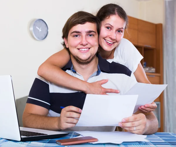 Family couple sitting at desk with documents