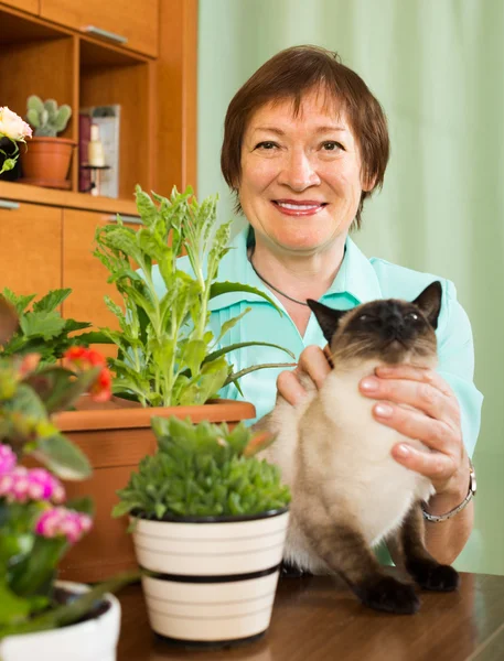Woman with cat and flower plants