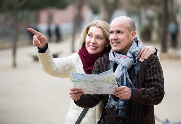Senior couple of travellers with map