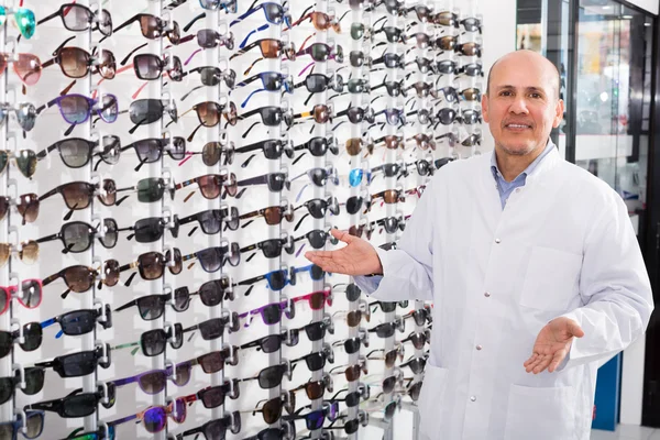 Male ophthalmologist in optics store