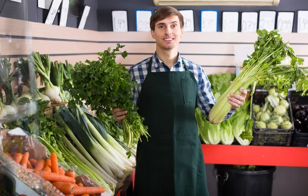 Grocery worker selling vegetables