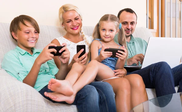 Portrait of  family playing with gadgets