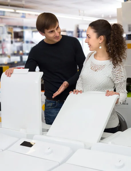 Family couple buying new clothes washer