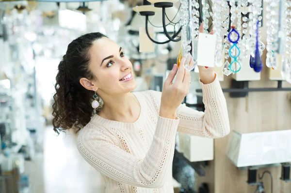 Woman doing shopping in lighting shop