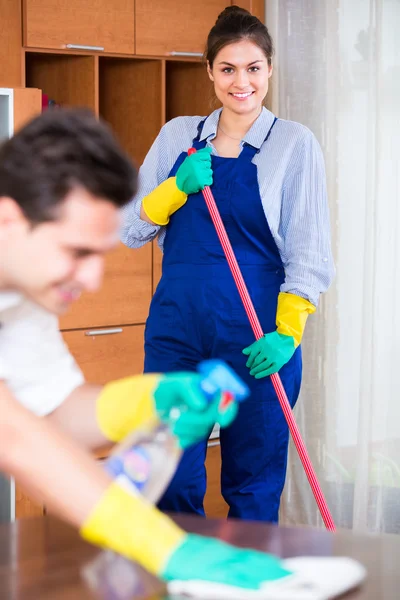 Cleaners in overalls with supplies