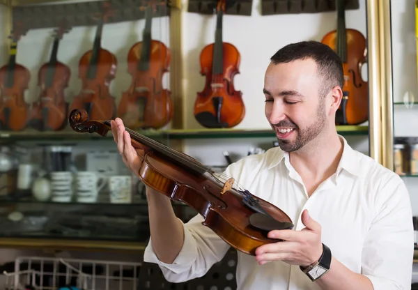 Male musician choosing violin
