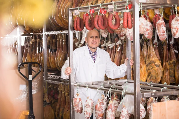 Technologist posing with wurst and jamon