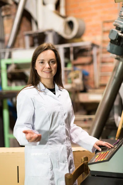 Woman programming process inside factory