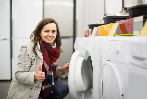 Woman buying new laundry machine