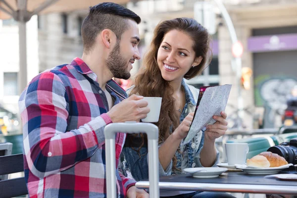 Tourist couple at open-air cafe