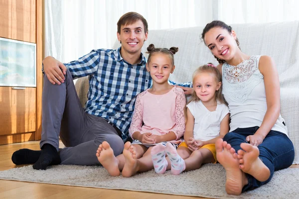 Relaxed family of four posing