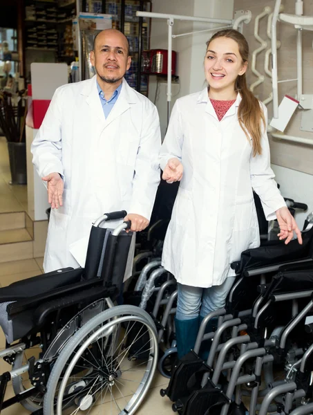 Man and young woman with mechanical wheelchairs