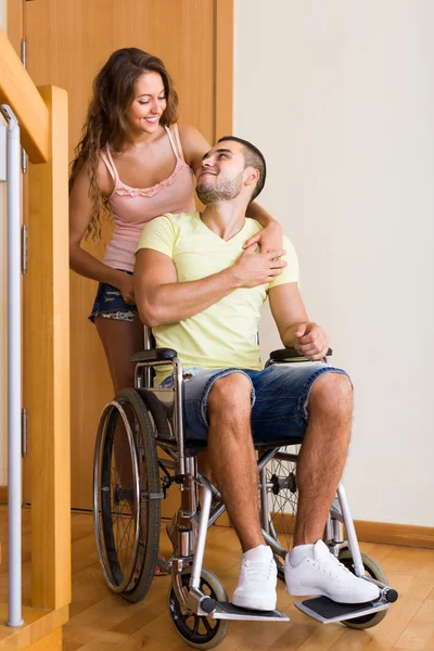 Woman with disabled husband at the door